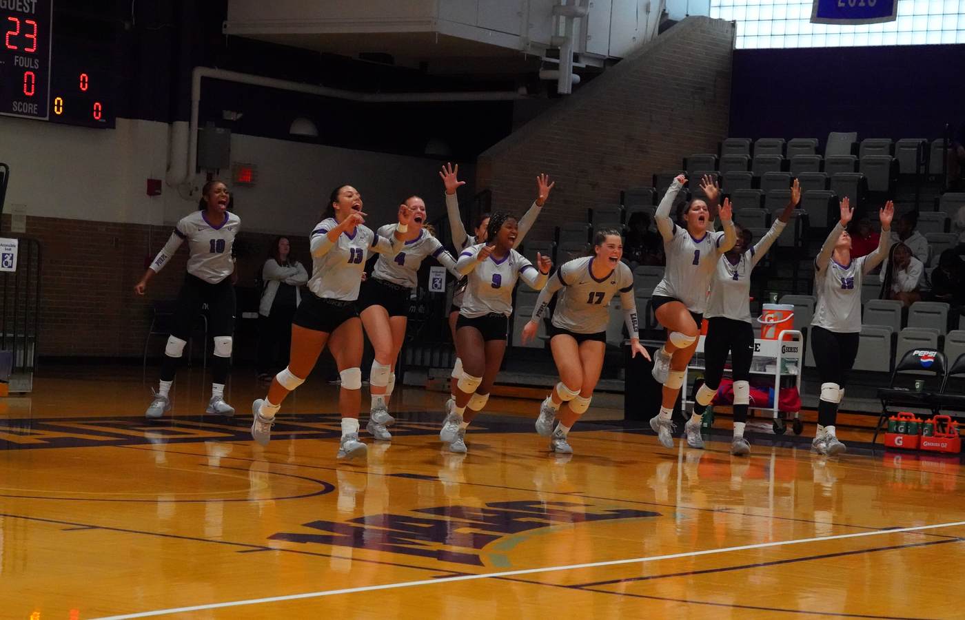 Niagara women’s volleyball players celebrating together on the court