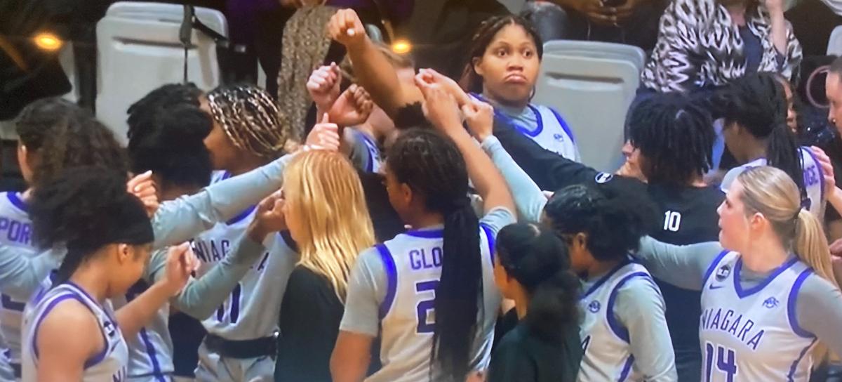 Niagara women’s basketball players gathering in a team huddle