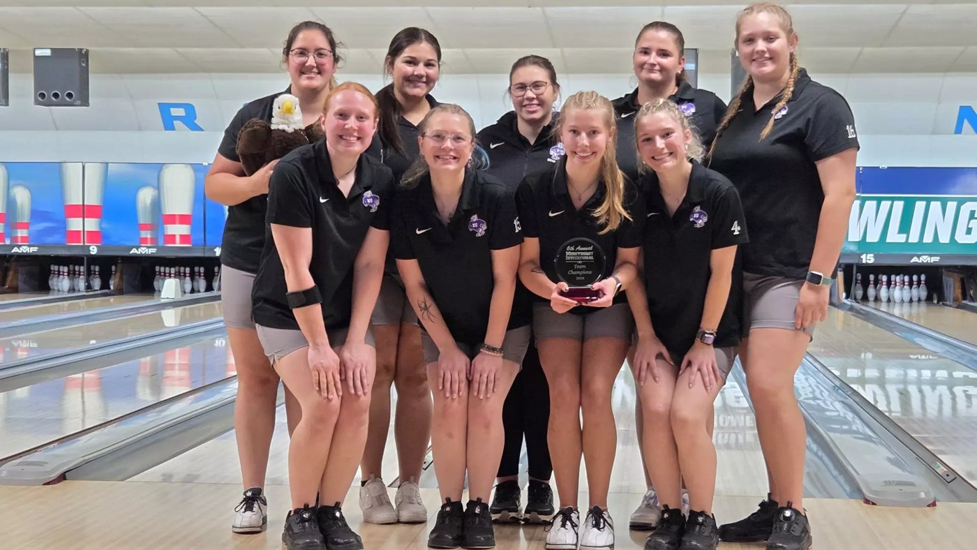 Niagara women’s bowling team posing together with a tournament trophy